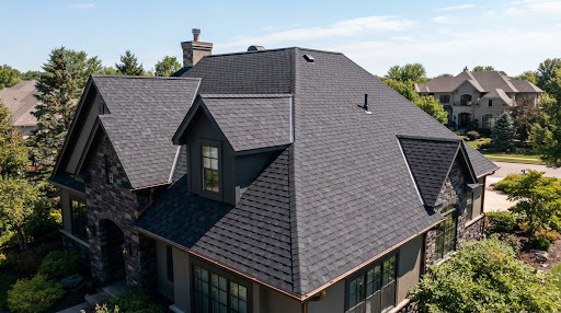Freshly installed dark charcoal architectural shingle roof with dimensional ridge caps and clean craftsmanship in Harrisburg PA